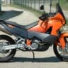 A black and red motorcycle on a road Image
