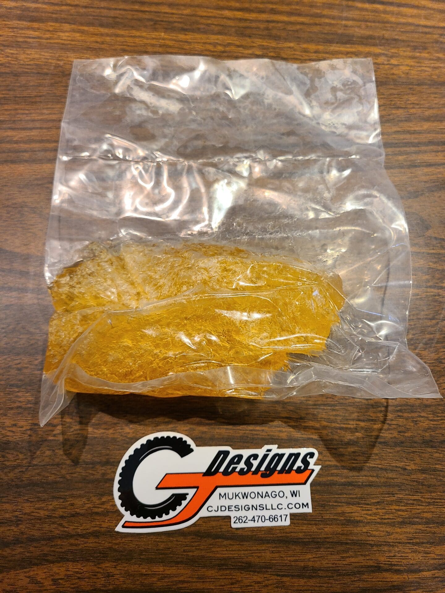 CJ Designs orange part in sealed plastic