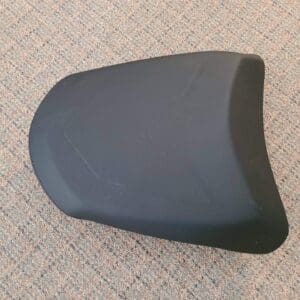 A small black color seat kept on the ground